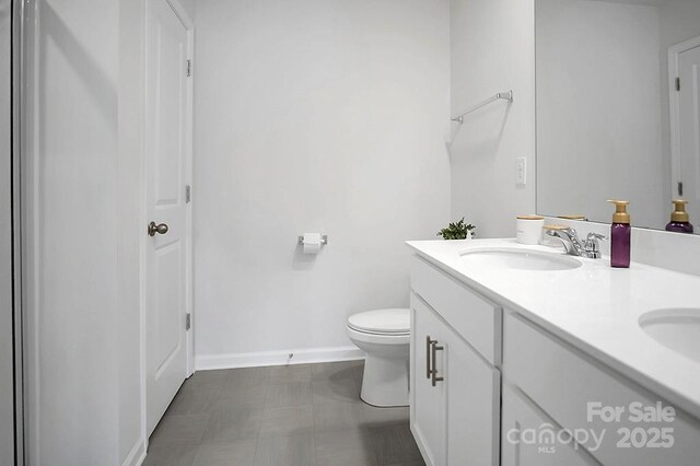 2013 Eastway Dr, Dallas, NC 28034 - bathroom featuring double vanity, toilet, tile patterned floors, and baseboards