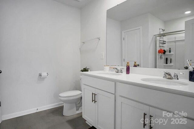 2013 Eastway Dr, Dallas, NC 28034 - bathroom with double vanity, toilet, baseboards, a shower, and recessed lighting
