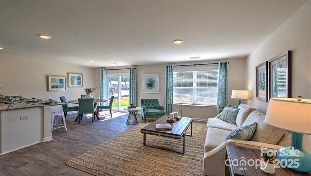 5137 Hyrule Dr, Charlotte, NC 28262 - living area with dark wood finished floors, baseboards, and recessed lighting