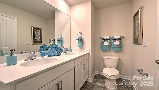5137 Hyrule Dr, Charlotte, NC 28262 - full bath featuring baseboards, toilet, double vanity, and stone finish flooring