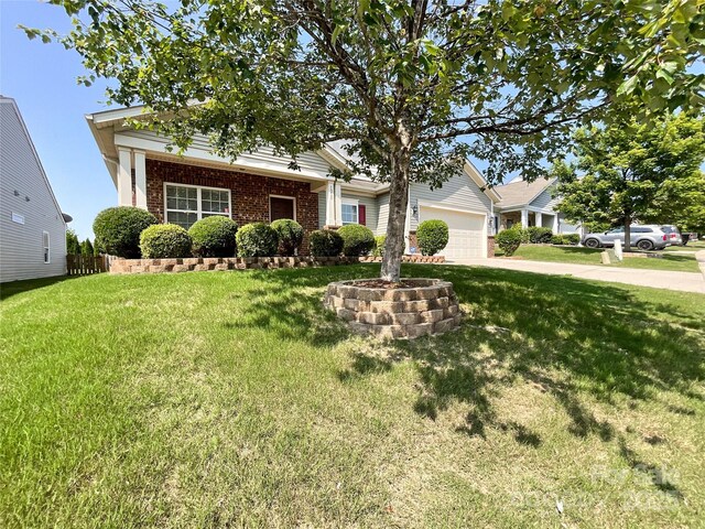 1228 Tranquil Falls Ln, Matthews, NC 28104 - view of front of house featuring brick siding, a garage, a front lawn, and driveway