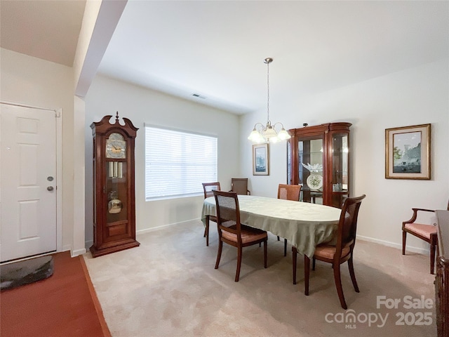 1228 Tranquil Falls Ln, Matthews, NC 28104 - dining room featuring light carpet, a chandelier, and baseboards