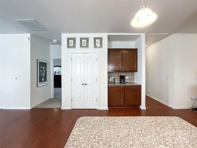 1228 Tranquil Falls Ln, Matthews, NC 28104 - kitchen with dark wood-type flooring, light countertops, baseboards, decorative light fixtures, and decorative backsplash