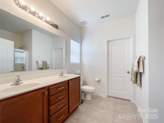 1228 Tranquil Falls Ln, Matthews, NC 28104 - bathroom featuring double vanity, a shower, toilet, and baseboards