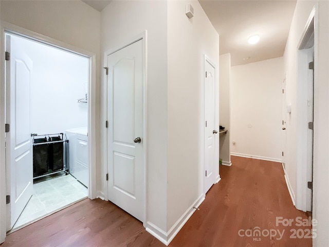 1228 Tranquil Falls Ln, Matthews, NC 28104 - corridor featuring light wood-style floors, washer / clothes dryer, and baseboards