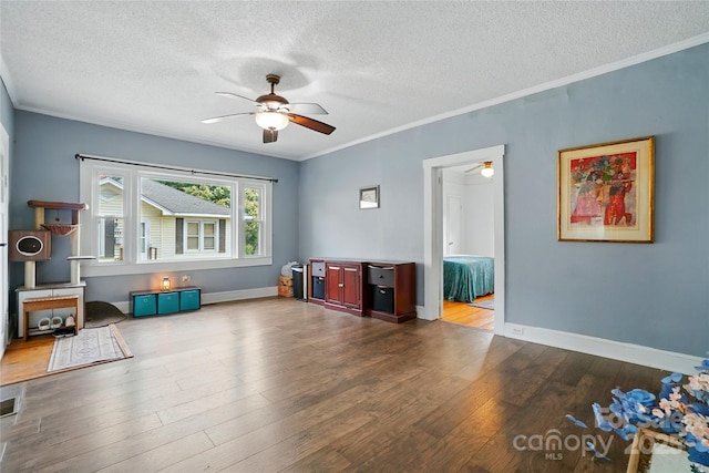 435 16th St, Cramerton, NC 28032 - living room featuring ceiling fan, a textured ceiling, wood finished floors, and ornamental molding