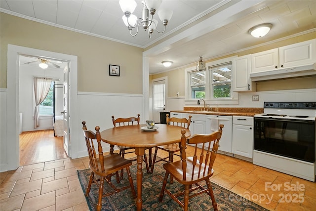 435 16th St, Cramerton, NC 28032 - dining room with wainscoting, healthy amount of natural light, crown molding, a chandelier, and light stone finish floors