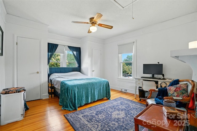435 16th St, Cramerton, NC 28032 - bedroom with multiple windows, attic access, light wood-type flooring, and a textured ceiling