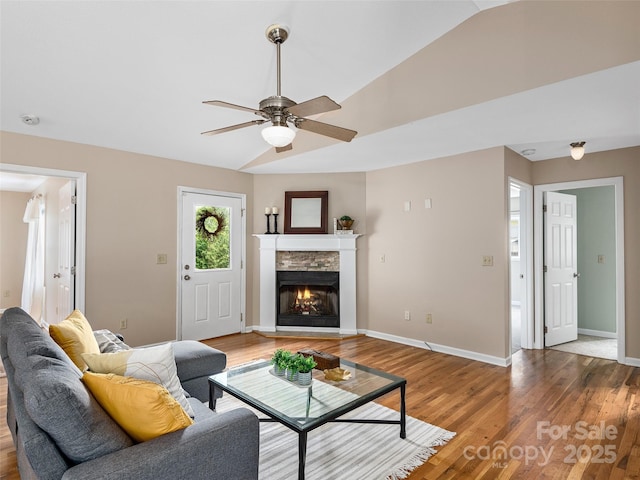 71 Midnight Ln, Waynesville, NC 28786 - living room featuring vaulted ceiling, ceiling fan, light wood-style floors, baseboards, and a stone fireplace
