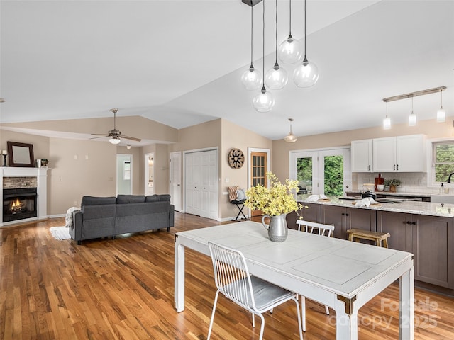71 Midnight Ln, Waynesville, NC 28786 - dining area with lofted ceiling, light wood-type flooring, healthy amount of natural light, and a ceiling fan