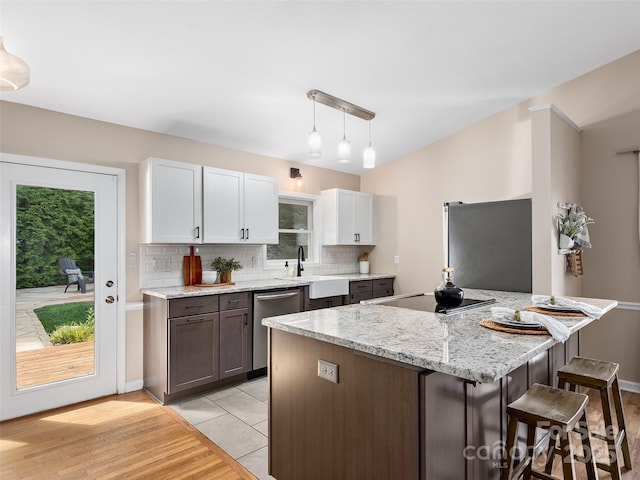 71 Midnight Ln, Waynesville, NC 28786 - kitchen with appliances with stainless steel finishes, a sink, a kitchen breakfast bar, tasteful backsplash, and healthy amount of natural light