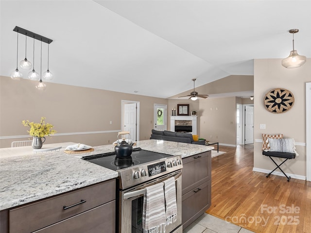 71 Midnight Ln, Waynesville, NC 28786 - kitchen with electric stove, a fireplace, vaulted ceiling, a ceiling fan, and pendant lighting