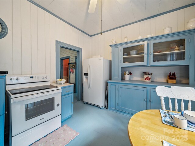 408 S Ellis St, Salisbury, NC 28144 - kitchen featuring blue cabinets, white appliances, glass insert cabinets, and wood walls