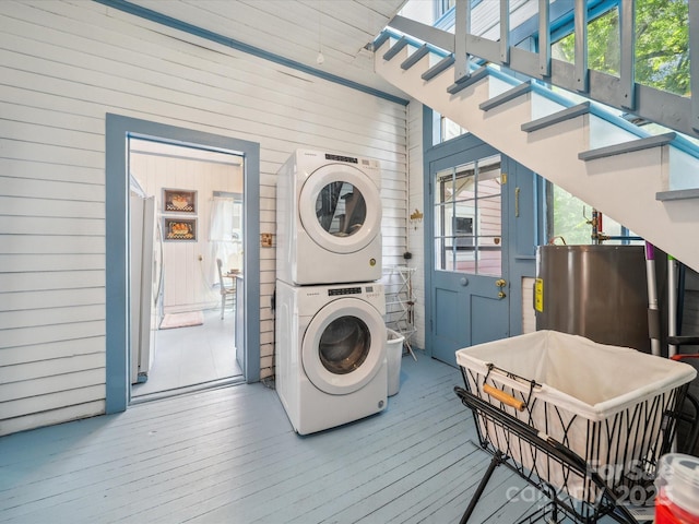 408 S Ellis St, Salisbury, NC 28144 - laundry area with estacked washer and dryer, wooden walls, hardwood / wood-style floors, and water heater