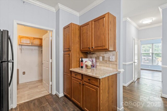 11911 Ridgeway Park Dr, Charlotte, NC 28277 - kitchen featuring freestanding refrigerator, dark wood finished floors, ornamental molding, light stone countertops, and backsplash