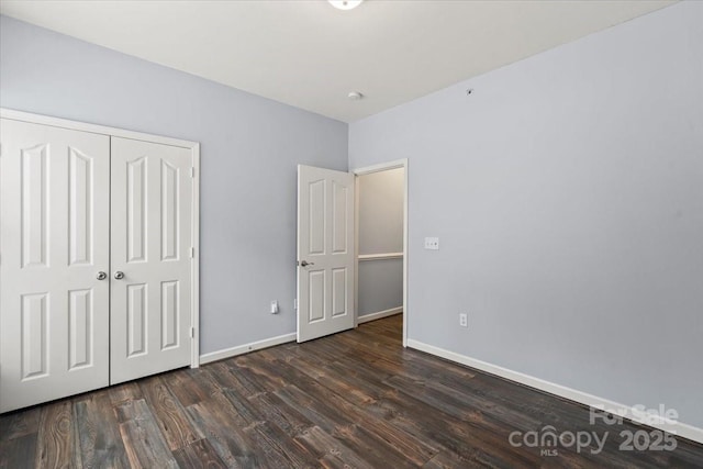 11911 Ridgeway Park Dr, Charlotte, NC 28277 - unfurnished bedroom featuring dark wood-style flooring, baseboards, and a closet