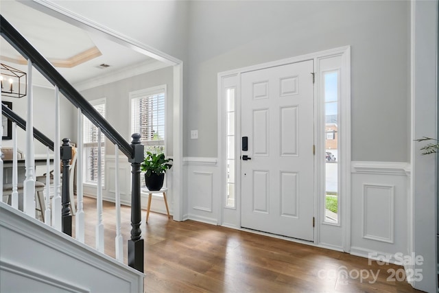1522 Napa St NW, Concord, NC 28027 - entrance foyer with stairway, a decorative wall, wood finished floors, crown molding, and a wainscoted wall