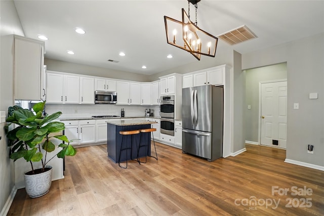 1522 Napa St NW, Concord, NC 28027 - kitchen with stainless steel appliances, white cabinetry, a kitchen island, decorative backsplash, and recessed lighting