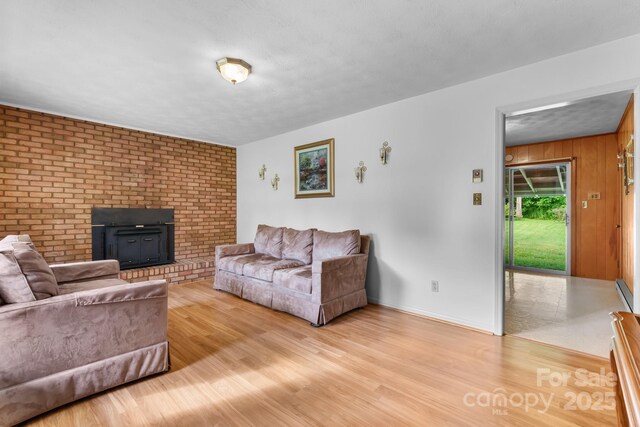 518 W School St, Maiden, NC 28650 - living area featuring a fireplace, light wood-style floors, and baseboards