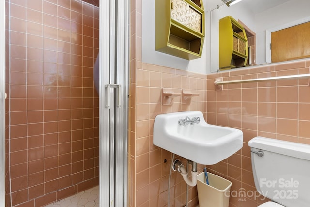 518 W School St, Maiden, NC 28650 - bathroom with a shower stall, tile walls, a sink, and toilet