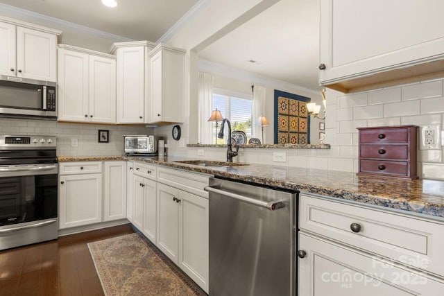 2066 Vermount Way, Indian Land, SC 29707 - kitchen with stainless steel appliances, crown molding, a chandelier, decorative backsplash, and white cabinets