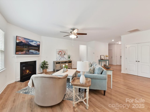 200 Sweet Briar Dr, Fort Mill, SC 29707 - living room featuring light wood-style floors, a ceiling fan, a fireplace with flush hearth, baseboards, and recessed lighting