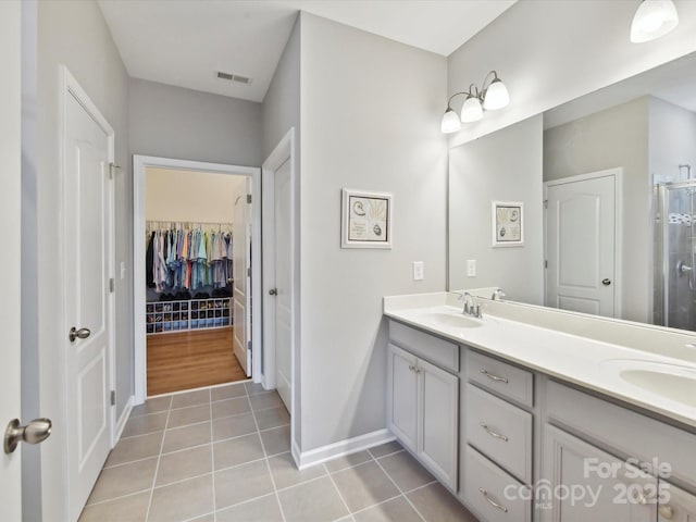 200 Sweet Briar Dr, Fort Mill, SC 29707 - full bathroom with double vanity, tile patterned floors, baseboards, a stall shower, and a walk in closet