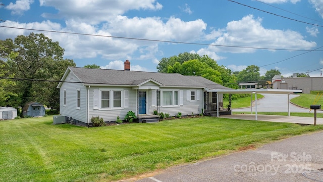 1266 18th St NE, Hickory, NC 28601 - view of front of house featuring a chimney, a front yard, and a shingled roof
