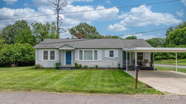 1266 18th St NE, Hickory, NC 28601 - view of front of house with an attached carport, a chimney, driveway, and a front yard
