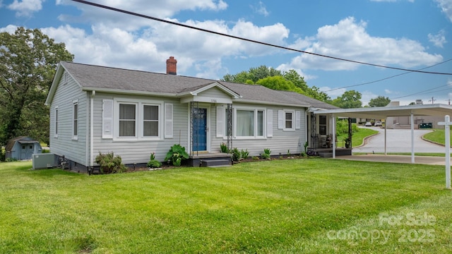 1266 18th St NE, Hickory, NC 28601 - view of front facade with a chimney, a front yard, and a shingled roof