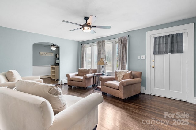 1266 18th St NE, Hickory, NC 28601 - living area with a ceiling fan, a baseboard heating unit, wood finished floors, and arched walkways