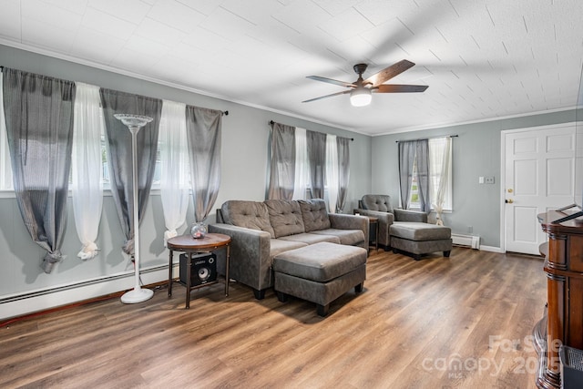 1266 18th St NE, Hickory, NC 28601 - living room with a baseboard radiator, ornamental molding, a ceiling fan, wood finished floors, and baseboards