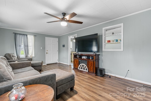 1266 18th St NE, Hickory, NC 28601 - living room with wood finished floors, crown molding, ceiling fan, and baseboards