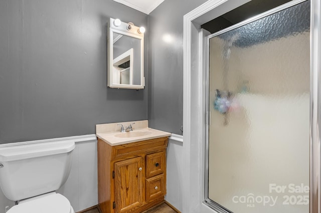 1266 18th St NE, Hickory, NC 28601 - bathroom featuring a stall shower, vanity, toilet, and a wainscoted wall