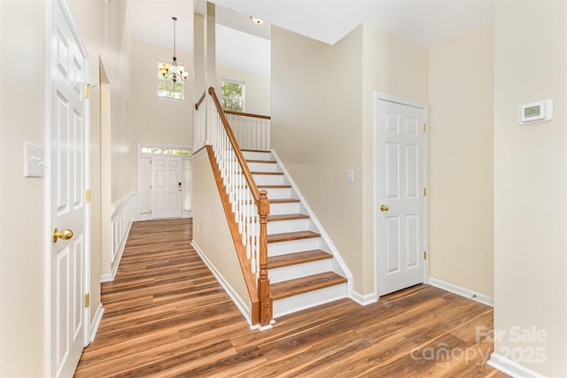 13305 Mallard Landing Rd, Charlotte, NC 28278 - stairs with wood finished floors, a chandelier, and baseboards
