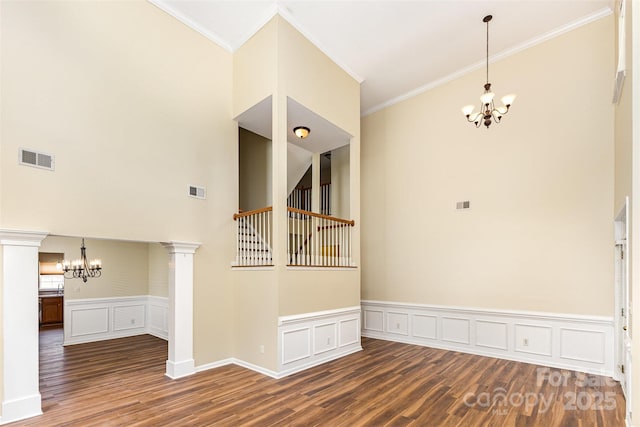 13305 Mallard Landing Rd, Charlotte, NC 28278 - unfurnished room featuring a chandelier, wood finished floors, a decorative wall, ornamental molding, and wainscoting