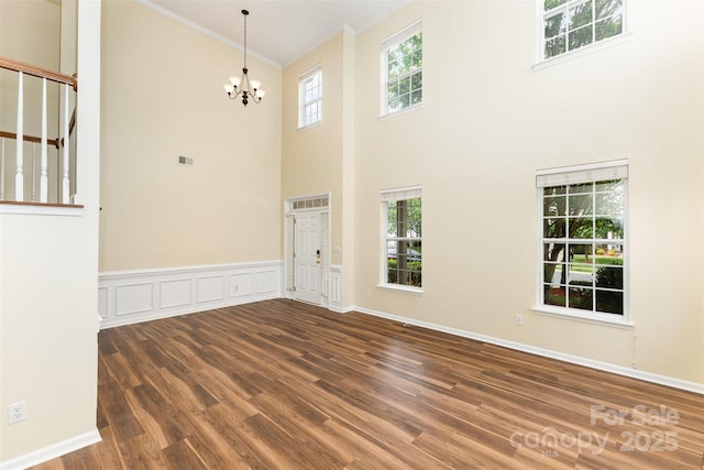 13305 Mallard Landing Rd, Charlotte, NC 28278 - foyer with ornamental molding, wood finished floors, a chandelier, a high ceiling, and stairway