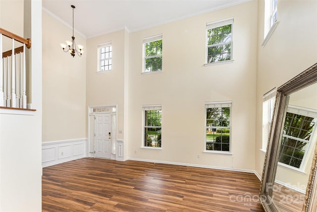 13305 Mallard Landing Rd, Charlotte, NC 28278 - entrance foyer with wood finished floors, crown molding, a chandelier, a towering ceiling, and a wainscoted wall