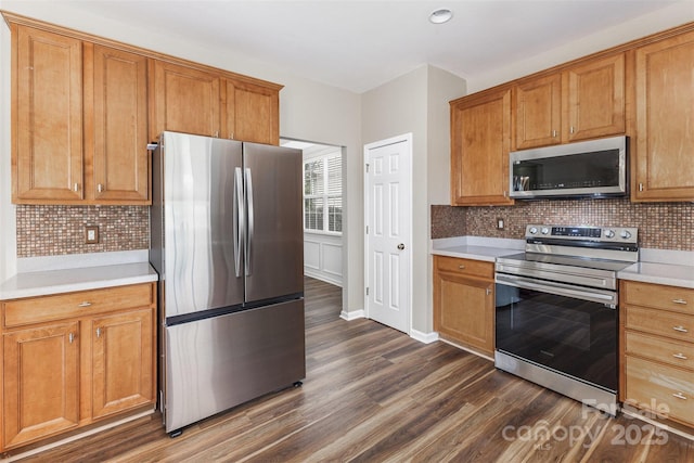 13305 Mallard Landing Rd, Charlotte, NC 28278 - kitchen with stainless steel appliances, dark wood-style floors, light countertops, backsplash, and brown cabinetry