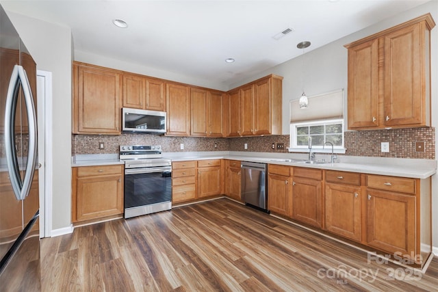 13305 Mallard Landing Rd, Charlotte, NC 28278 - kitchen with stainless steel appliances, a sink, dark wood finished floors, and light countertops