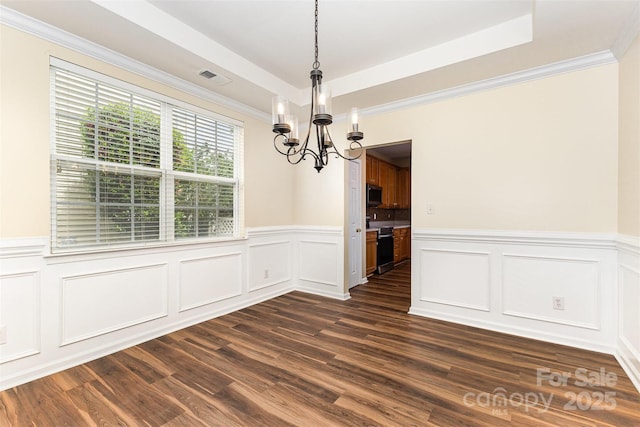 13305 Mallard Landing Rd, Charlotte, NC 28278 - unfurnished dining area featuring a chandelier, a wainscoted wall, a tray ceiling, dark wood-type flooring, and a decorative wall