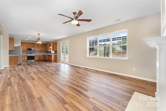 13305 Mallard Landing Rd, Charlotte, NC 28278 - unfurnished living room with a chandelier, baseboards, wood finished floors, a ceiling fan, and recessed lighting