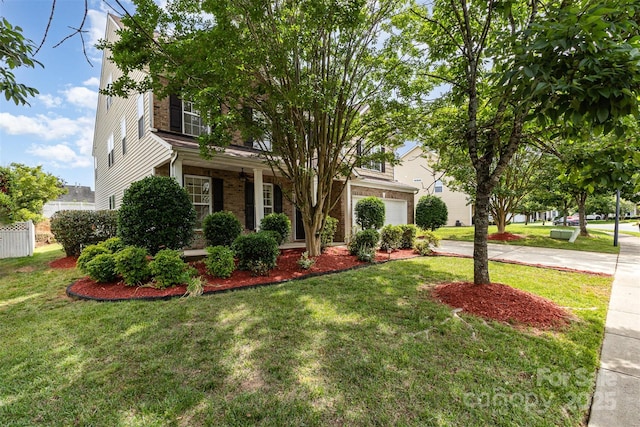 13305 Mallard Landing Rd, Charlotte, NC 28278 - view of property hidden behind natural elements with concrete driveway, a front lawn, an attached garage, brick siding, and a porch