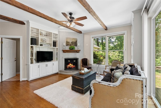 310 Southwood Ln, Columbus, NC 28722 - living room with a lit fireplace, ceiling fan, beam ceiling, wood finished floors, and ornamental molding