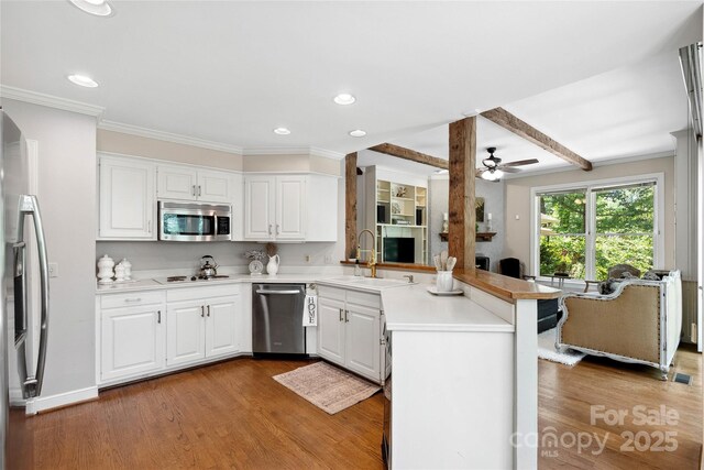 310 Southwood Ln, Columbus, NC 28722 - kitchen with appliances with stainless steel finishes, a peninsula, light wood finished floors, recessed lighting, and ceiling fan