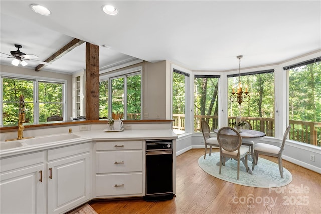 310 Southwood Ln, Columbus, NC 28722 - kitchen with white cabinetry, a chandelier, light countertops, ceiling fan, and light wood-type flooring