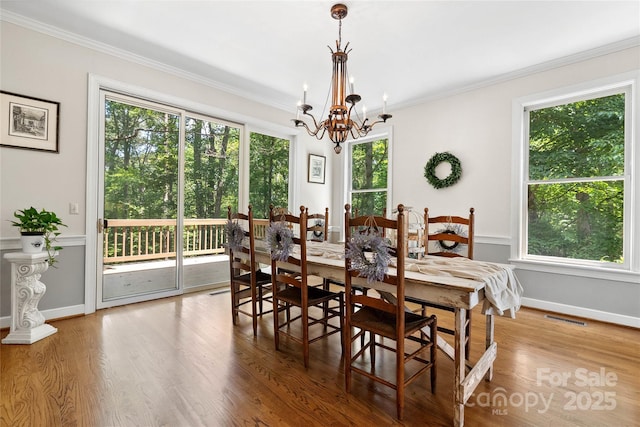 310 Southwood Ln, Columbus, NC 28722 - dining room featuring a chandelier, crown molding, and wood finished floors