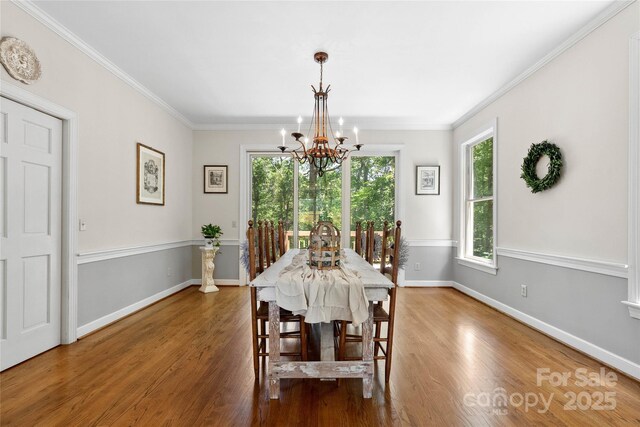 310 Southwood Ln, Columbus, NC 28722 - dining space featuring a chandelier, wood finished floors, and crown molding