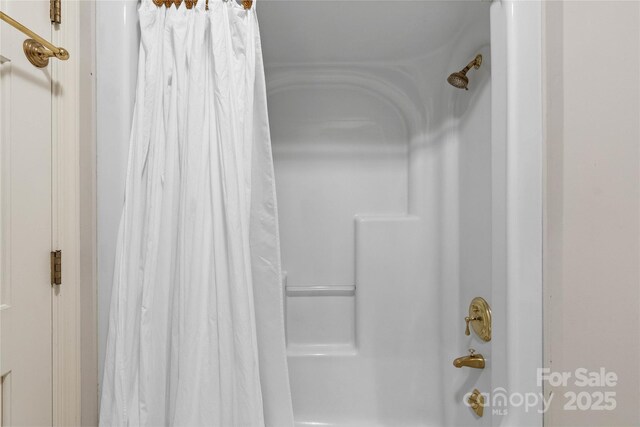 310 Southwood Ln, Columbus, NC 28722 - bathroom featuring shower / bath combo with shower curtain