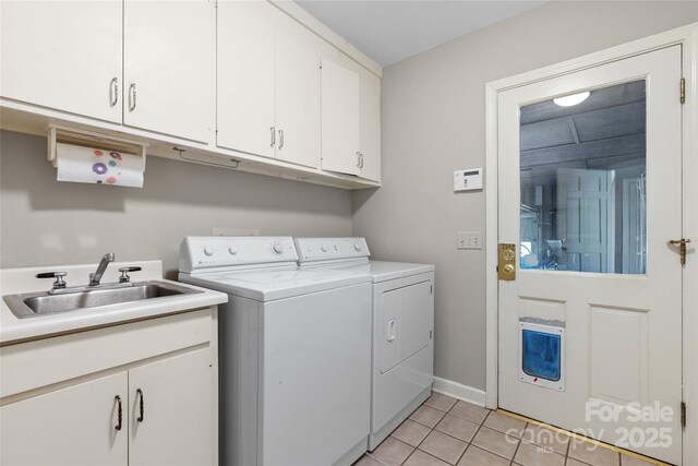 310 Southwood Ln, Columbus, NC 28722 - laundry area with independent washer and dryer, light tile patterned flooring, and cabinet space